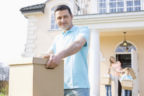 Professional movers handling furniture in a Swiss Cottage residential building